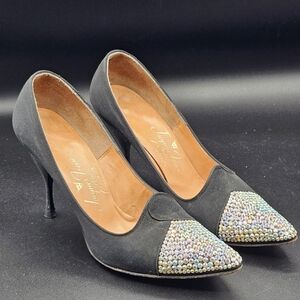 Jacques Heim pumps with a rhinestone-embellished toe.